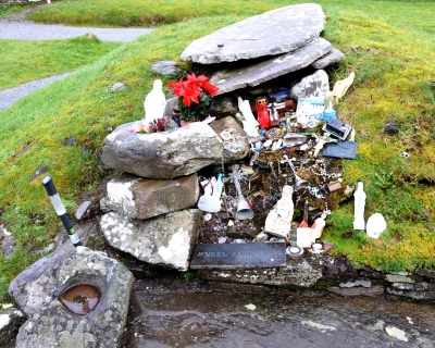The grave of St Gobnait which is a focus of devotional activity. It is a station on the rounds and people frequently leave votive offerings here.