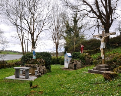 Numerous features have been added to the site, including the statue of saint John over the well and the shrine for votives on the right. A statue of Our Lady adorns the old altar, to which a new altar has been added. A large crucifix is clearly dominant, as well. The site is very well tended to.
