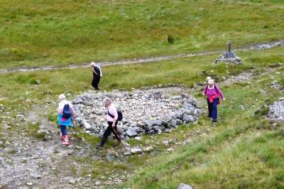 Pilgrims circling on of the leacht at the site. They throw a stone into the centre after completing their rotations. 