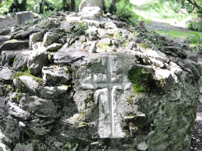 A slightly embellished cross on the beehive structure encasing St John’s Well, Carrigaline. As part of the annual St John’s Eve ceremony a single pilgrim imprints the cross on behalf of the gathered crowd as the a collective rosary is prayed